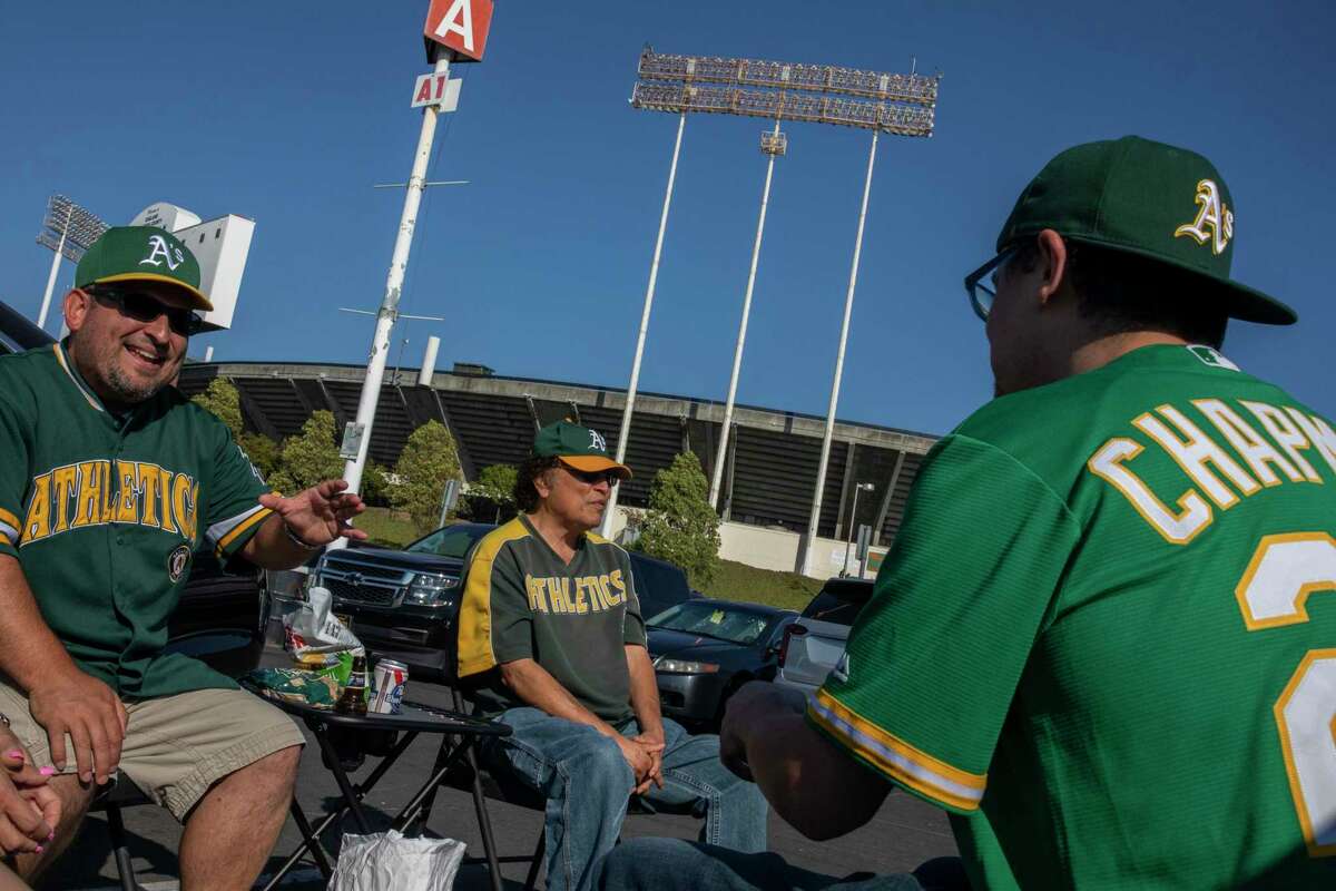 Jose Castellanoz Jr., Jose Castellanoz and Arcadio Castellanoz Jr. talk outside Oakland Coliseum before going in to see the A’s take on Cleveland.