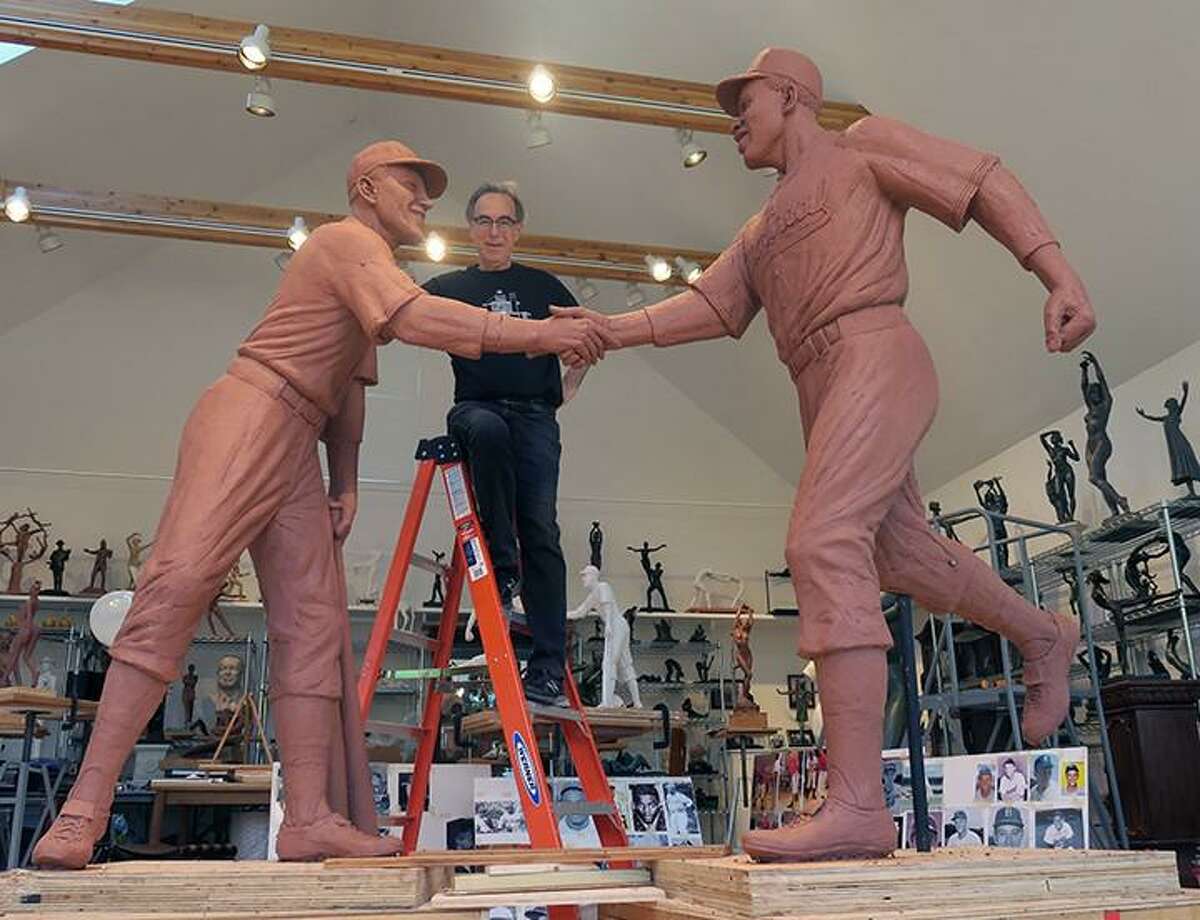 Marc Mellon working on "The Handshake of the Century" sculpture