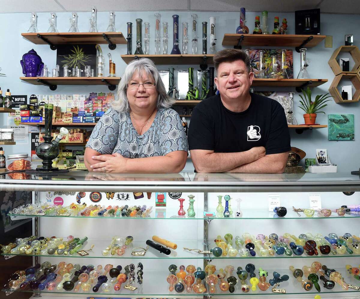 Mary Jane DuPont and her husband, Michael, photographed in their store, Bangarang, in Wallingford surrounded by pipes and bongs on July 16, 2021.