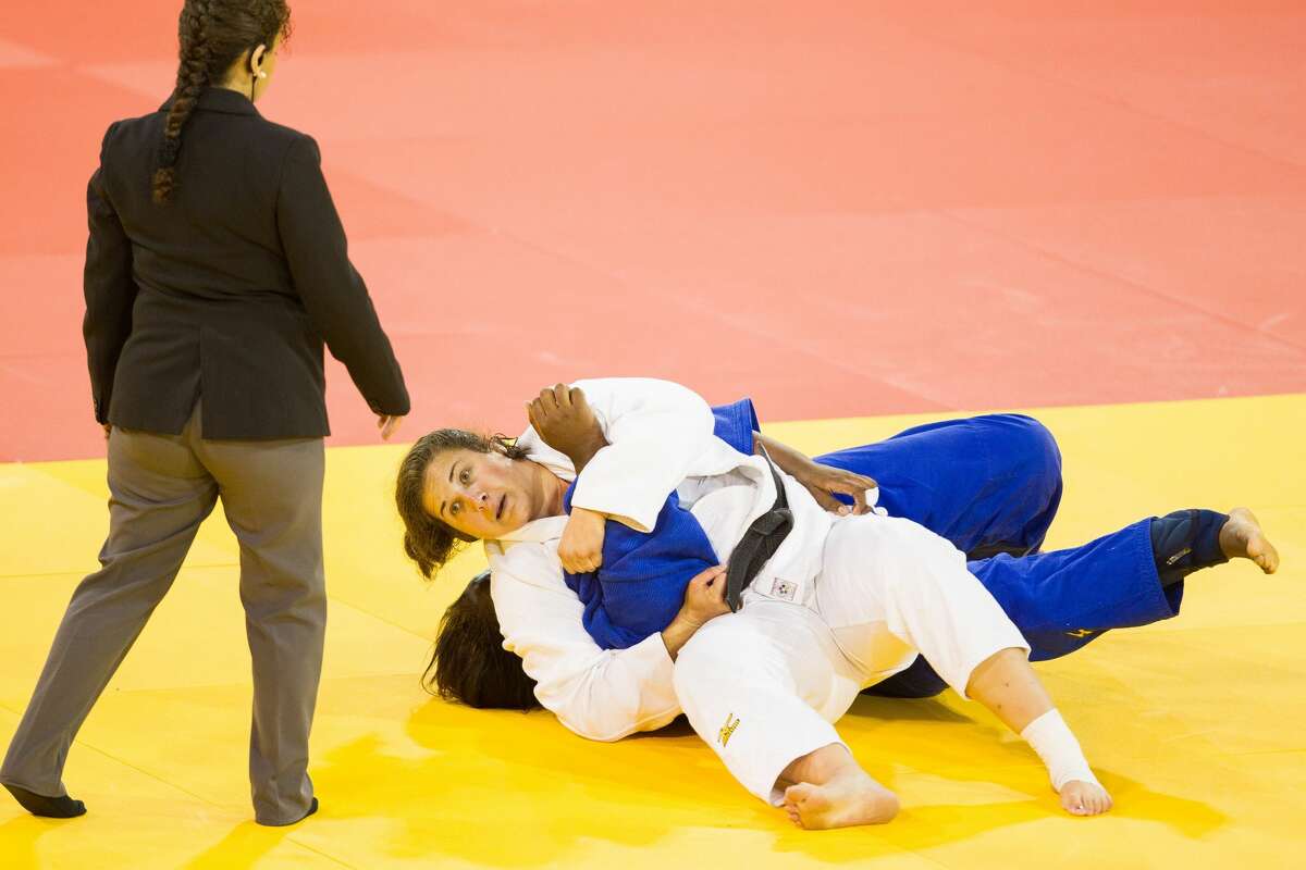Nina Cutro-Kelly of the United States (white) pins Leidi German (blue) of the Dominican Republic to win their 1/4 final contest in the women's judo +78kg class at the 2015 Pan American Games in Toronto, Canada, July 14, 2015. AFP PHOTO/GEOFF ROBINS (Photo credit should read GEOFF ROBINS/AFP via Getty Images)