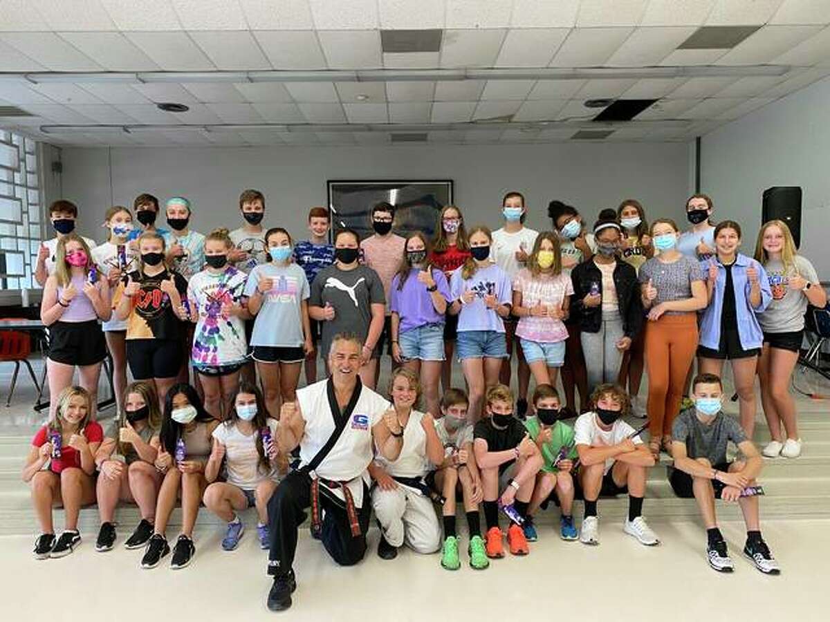 Senior Master Instructor Rich Grogan with G.O. campers on Thursday. Some masks were removed for the purpose of the photo.