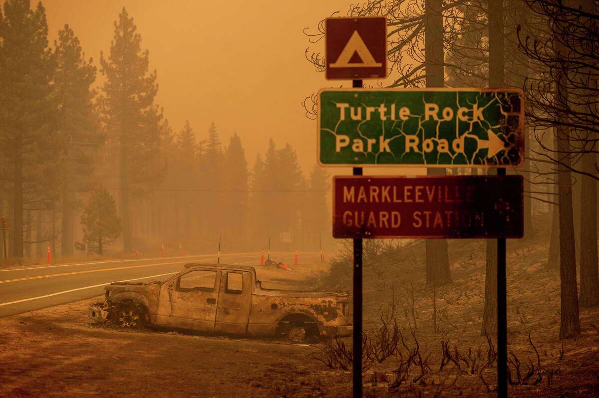 A burnt out car lies on the side of a road as the Tamarack Fire burns in the community of Markleeville in Alpine County, Calif., On Saturday, July 17, 2021.