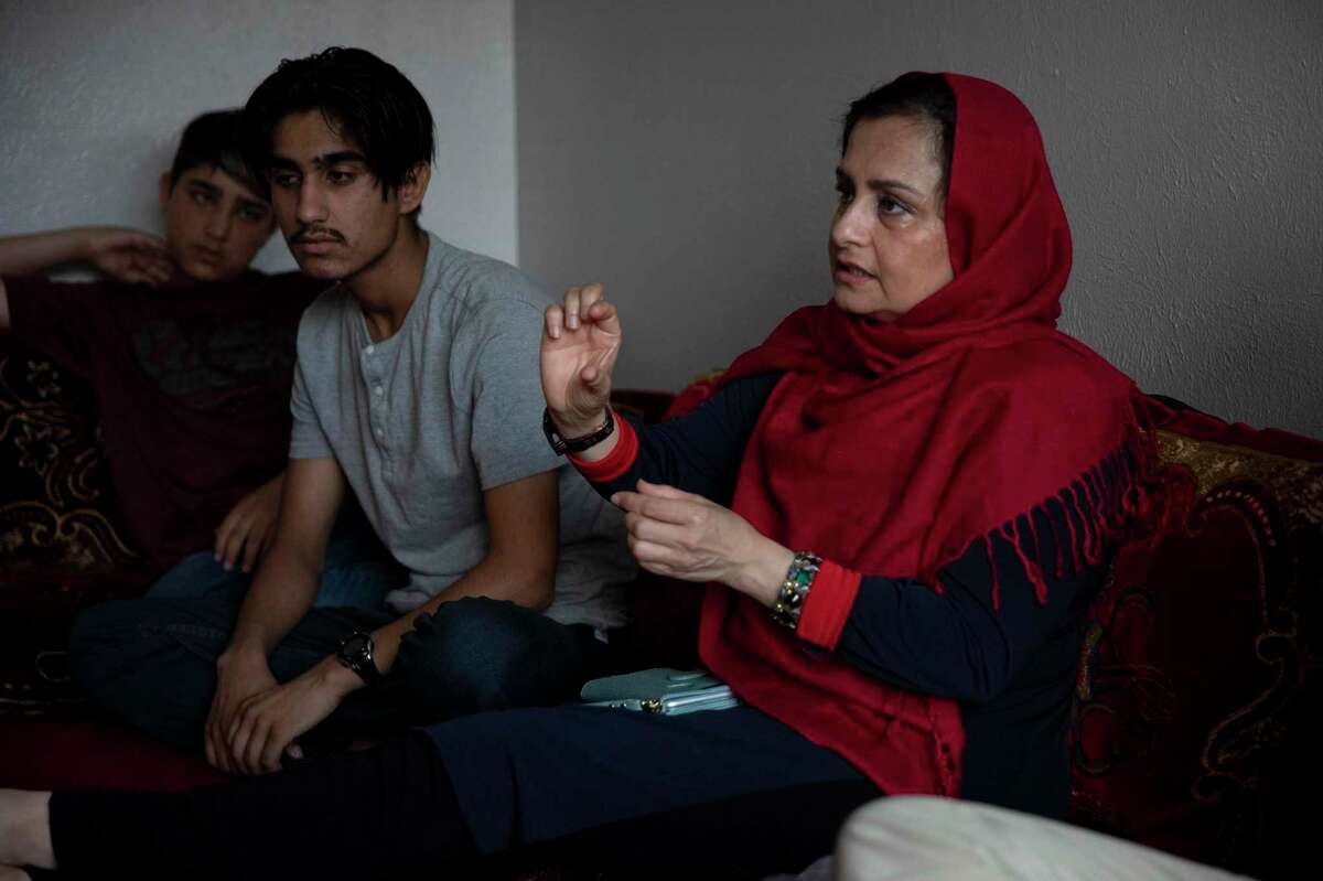 Farhana Khan, founder of Razakaar Foundation, helps refugees seek independence by providing access to health care, ESL classes and employment resources. Kahn, surrounded by the sons of Gultawarkhan Hussain Gu,y who arrived in Texas from Afghanistan 16 months ago, goes through basic instructions on dental care to help them prepare for a visit to the dentist.