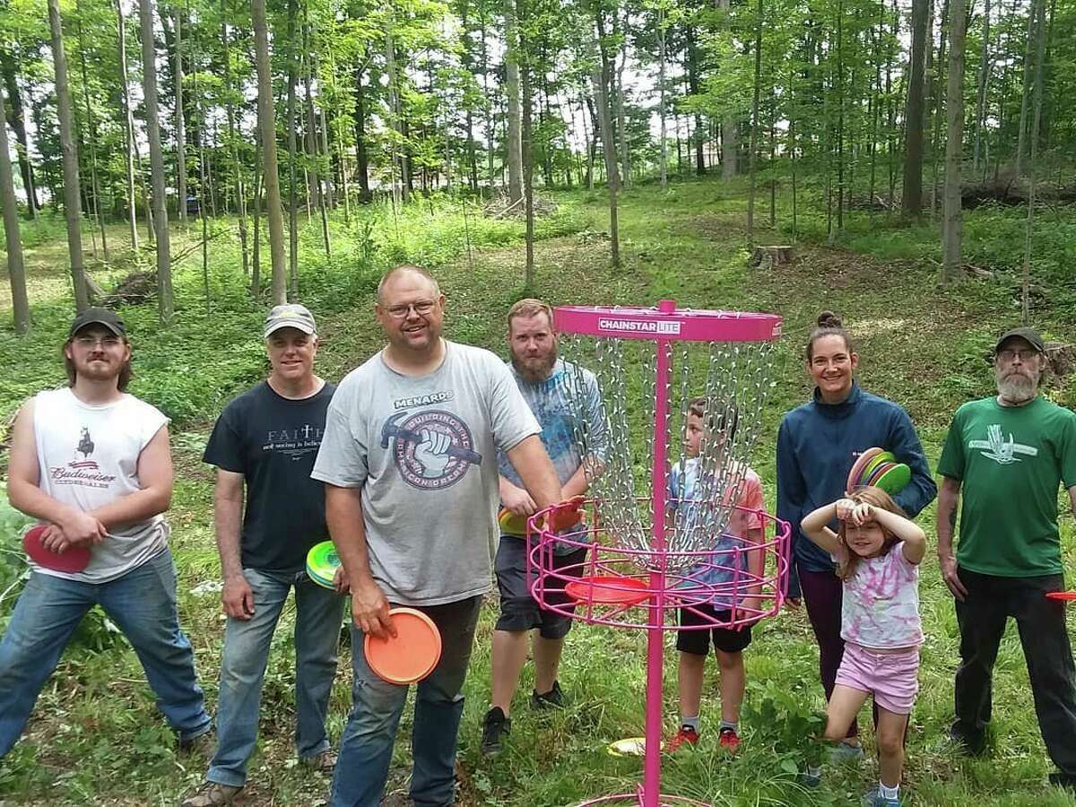 Volunteers help to clear the brush in preparation for the disc gold course at Rambadt Park in Reed City. Once a hole is cleared, a temporary basket is set up to do a dry run and see if further clearing needs done. (Submitted photo)