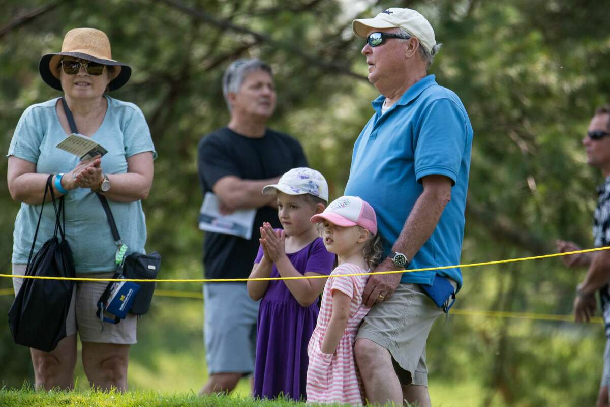 A family of spectators claps for a good drive, Saturday, July 17, 2021, at the Dow Great Lakes Bay Invitational.
