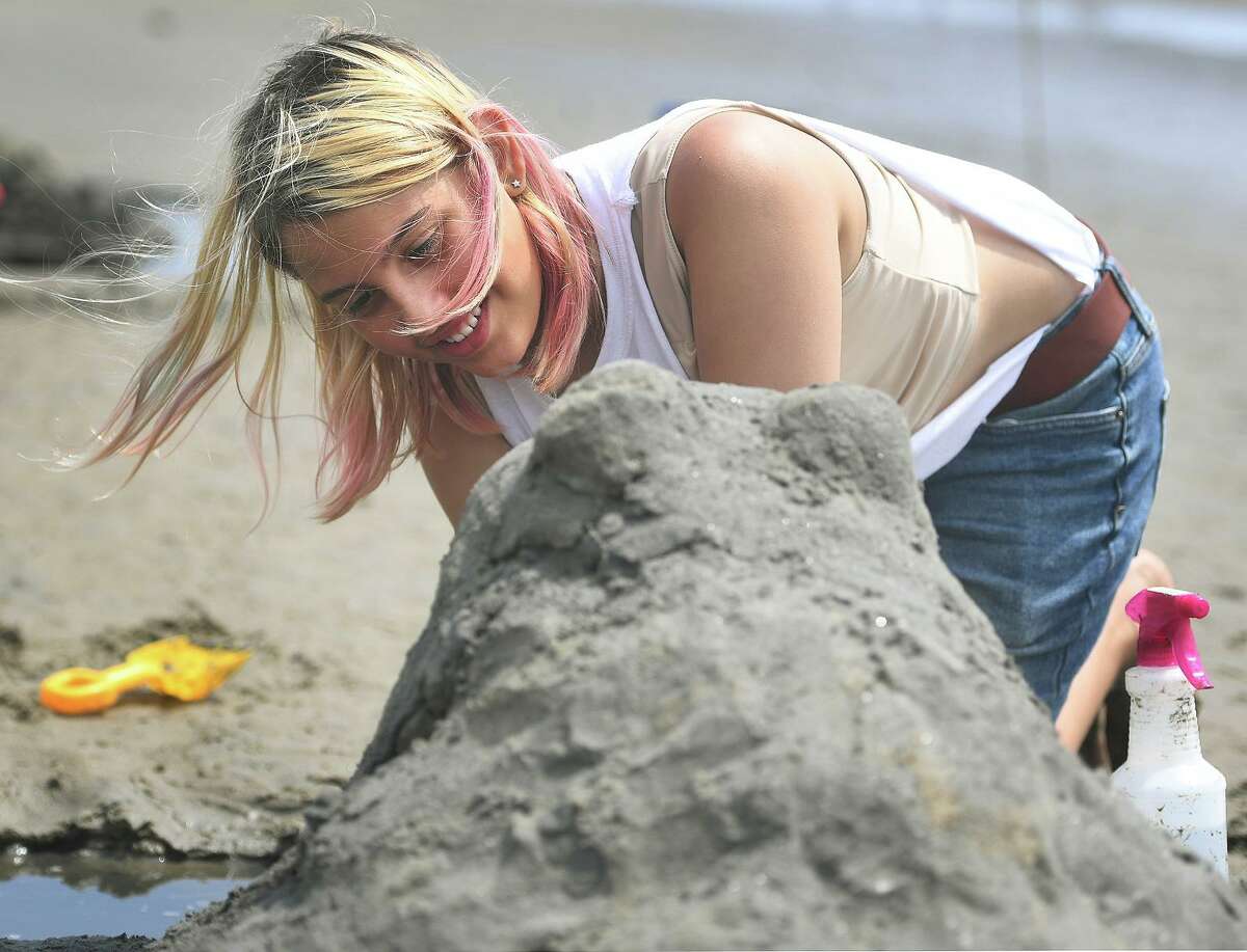 Evan Santoro, 13, of Milford, makes a sand sculpture frog during the annual sand sculpture competition at Walnut Beach in Milford Conn. on Sunday, July 18, 2021. Live judging was cancelled for fear of rain, but contestants were still able to submit photographs of their finished sculptures for judging in a virtual competition.