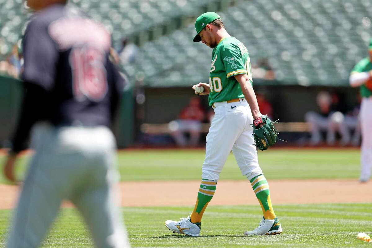 Oakland Athletics' starting pitcher Chris Bassitt reacts to giving up first pitch home run in 1st inning to Cleveland Indians' Bradley Zimmer during MLB game at Oakland Coliseum in Oakland, Calif., on Sunday, July 18, 2021.