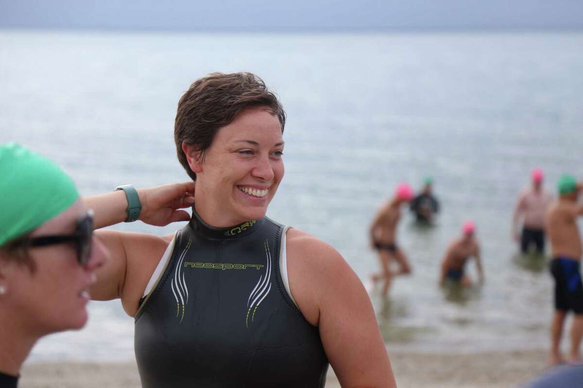 Alessandra Nassi, a recent arrival to Westport, takes part in her first Point to Point Swim at Compo Beach on Sunday, July 18, 2021, in Westport, Conn. On Sunday morning, more than 60 swimmers circled the eastern beach, covering a mile in the water in three tiers of ability - expert, intermediate and amateur. The one-mile open water race raises money to support the YMCA's Annual Campaign. The campaign fund provides financial assistance for programs like swim lessons, child care and camp.