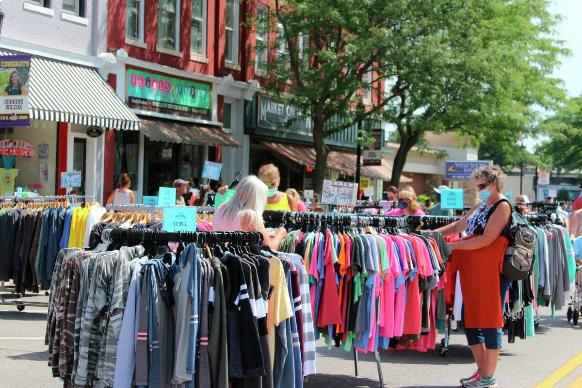 A visitor to Frankfort's Street Sale checks out discounted clothing from one of Frankfort's many downtown businesses. (File Photo)