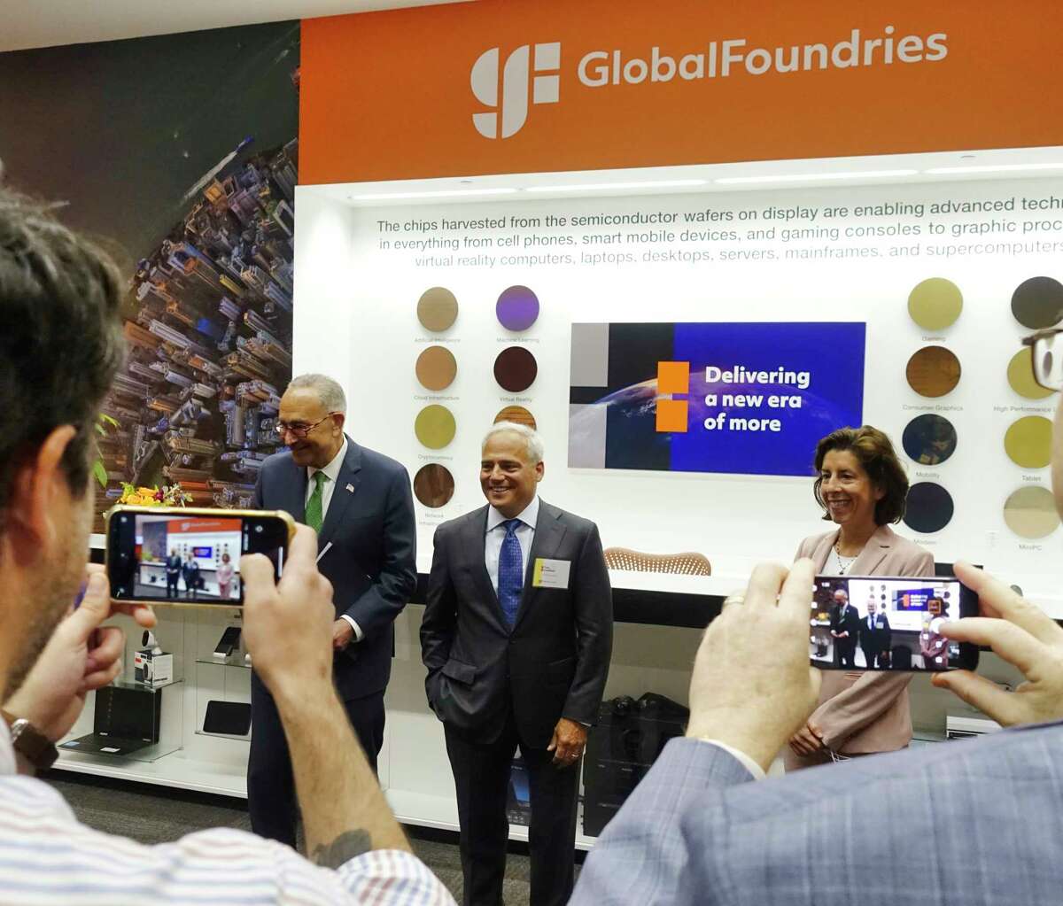 Senate Majority Leader Charles Schumer, left, Globalfoundries CEO Tom Caulfield, center, and U.S. Commerce Secretary Gina Raimondo, poses for photos at Globalfoundries on Monday, July 19, 2021, in Malta, N.Y. Caulfield announced at the Monday event that a second chip plant will be built in Malta. (Paul Buckowski/Times Union)