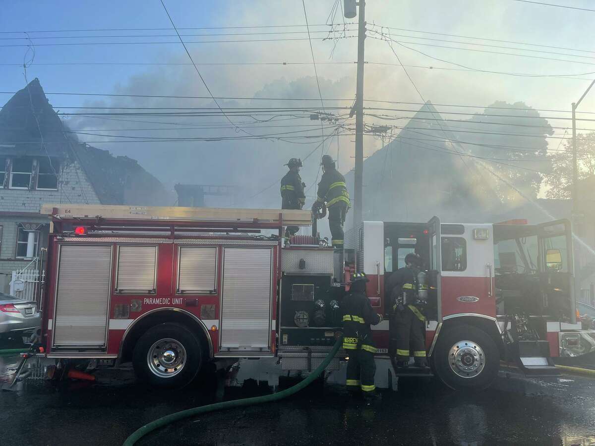 Oakland firefighters at the scene of a three-alarm fire that destroyed several homes in West Oakland. No injuries were reported.