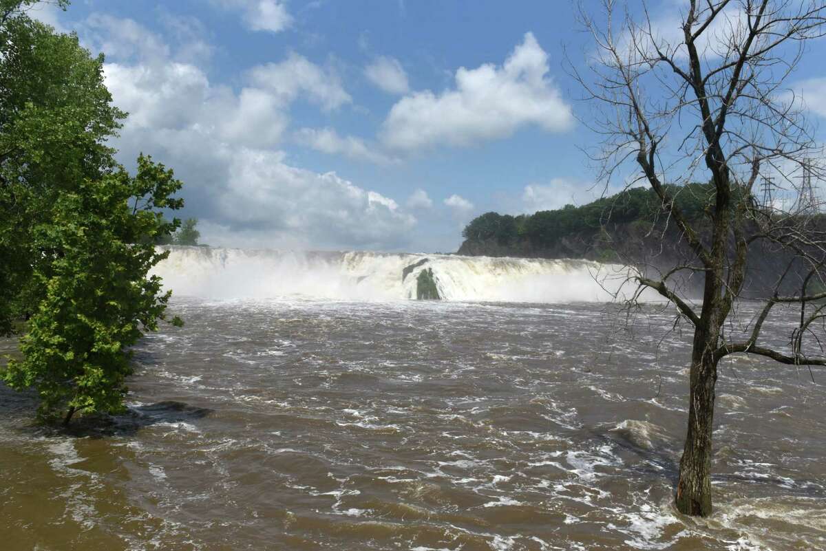Water from the Mohawk River thunders over Cohoes Falls on Monday, July 19, 2021, at Falls View Park in Cohoes, N.Y. High waters levels from recent heavy rains have closed the Erie Canal from Lock E-2 in Waterford to Lock E-19 in Frankfort. (Will Waldron/Times Union)