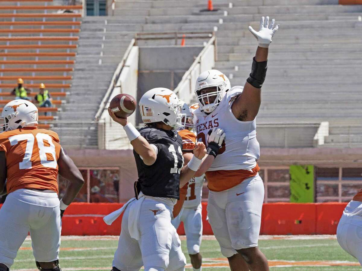 Texas defensive lineman Keondre Coburn tries to block a pass by quarterback Casey Thompson during the second half of the Texas Orange and White Spring Scrimmage in Austin, Texas, Saturday, April 24, 2021. (AP Photo/Michael Thomas)