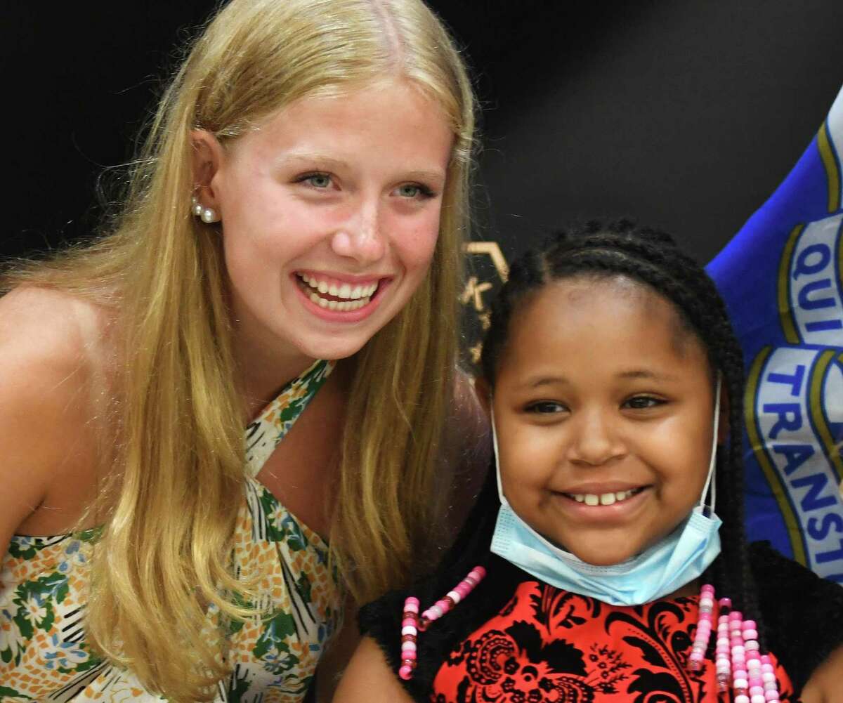 Norwalk lifeguard Morgan Saunders, 17, left, meets with Alexis Rowe, 9, the girl whose live she saved, during a ceremony at the Norwalk Police Department in Norwalk, Conn. Monday, July 19, 2021. Saunders saved Rowe from drowning at Calf Pasture Beach late last month and was honored with a cilivian award for her heroic action on Monday.