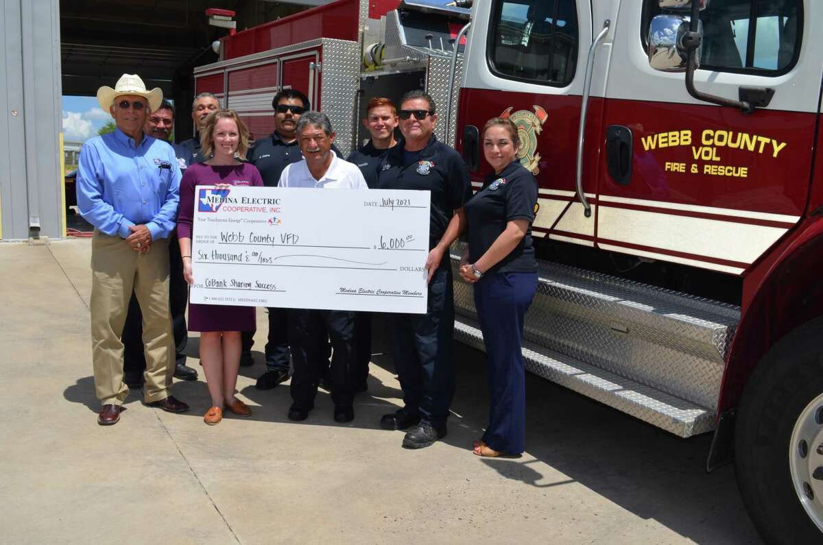 Pictured are J.L. Gonzalez and Katy Haby of Medina Cooperative, Webb County Volunteer Fire Chief Rick Rangel, Araceli Solis and members of the fire department.