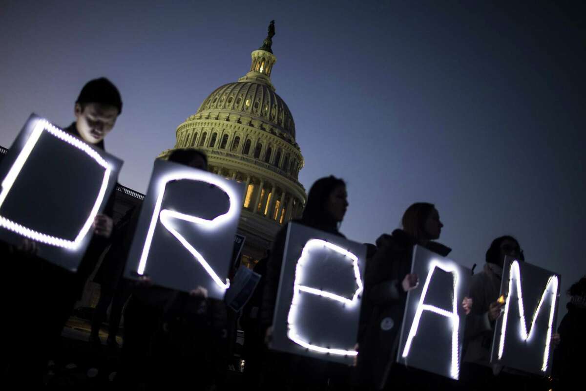 Demonstrators hold illuminated signs during a rally supporting the Deferred Action for Childhood Arrivals program, or the Dream Act, outside the U.S. Capitol building in Washington, D.C., on Jan. 18, 2018.