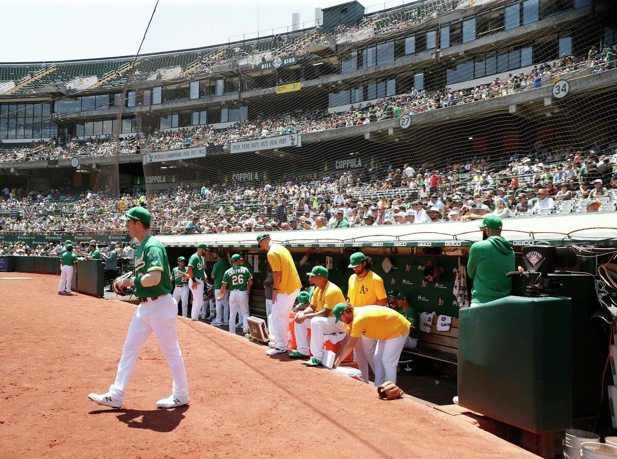 Oakland Athletics' Mark Canha heads to left field before start of A's game against Cleveland Indians at Oakland Coliseum in Oakland, Calif., on Sunday, July 18, 2021.