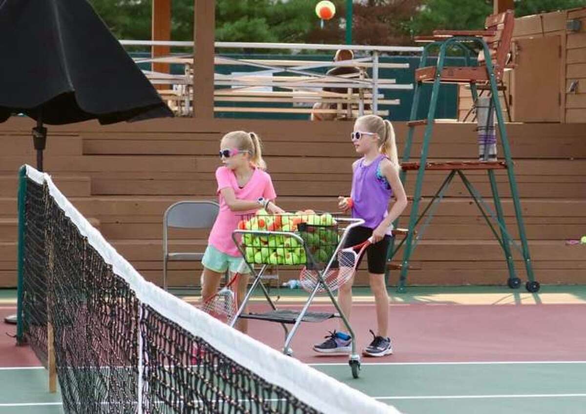 Kids learning to play tennis at a past Kids Night during the Edwardsville Futures tennis tournament at the EHS Tennis Center.