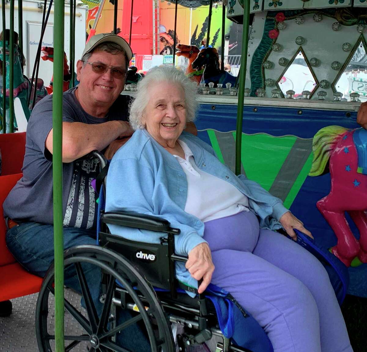 With the help of Skerbeck Family Carnival staff at the Mecosta County Fairgrounds, 95-year-old Mereda Bailey lived her longtime dream of riding the fair's colorful merry-go-round ride. (Courtesy/Nancy Stephan)