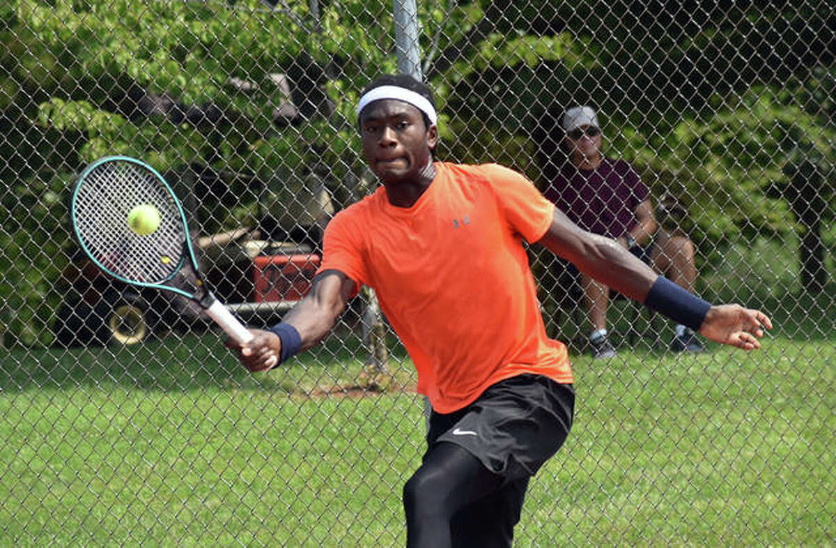 Jibril Nettles finesses a return shot during his match against Kalman Boyd in the second round of the Qualifying Tournament on Tuesday inside the EHS Tennis Center in Edwardsville.