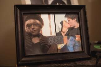 A picture frame with several photos and keepsakes