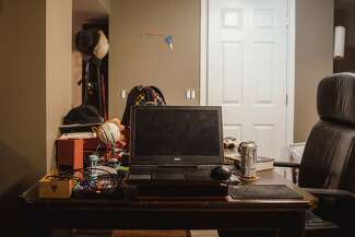 Joshua’s computer sits on a desk with other equipment