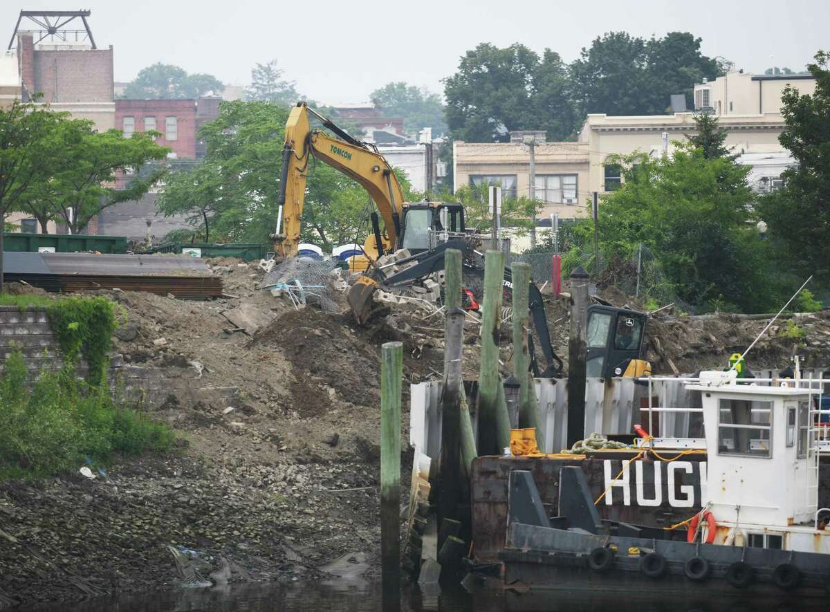 Crews repair the seawall in Port Chester, N.Y. as seen from across the Byram River in Greenwich, Conn. Tuesday, July 20, 2021. Work has begun on the marina bulkhead on the Port Chester side of the river and will take an estimated two years to complete.