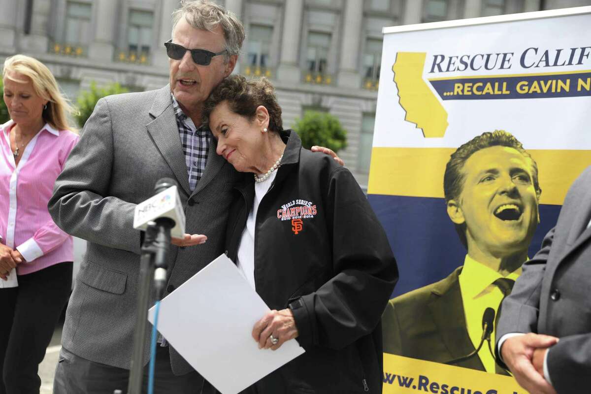 Marc Klaas (left) and Harriet Salarno (right), founder of Crime Victims United of California, hug during a press conference on July 20 outside of San Francisco City Hall advocating for the recall of Gavin Newsom.
