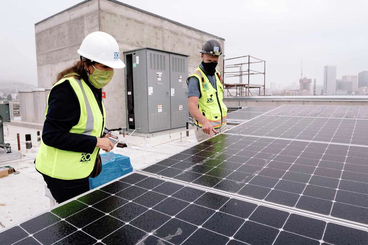 Solar panels are shown being installed on the roof of a low-income apartment in 2020. San Francisco set new, more aggressive climate change goals Tuesday, including getting to net zero greenhouse gas emissions produced in the city by 2040.