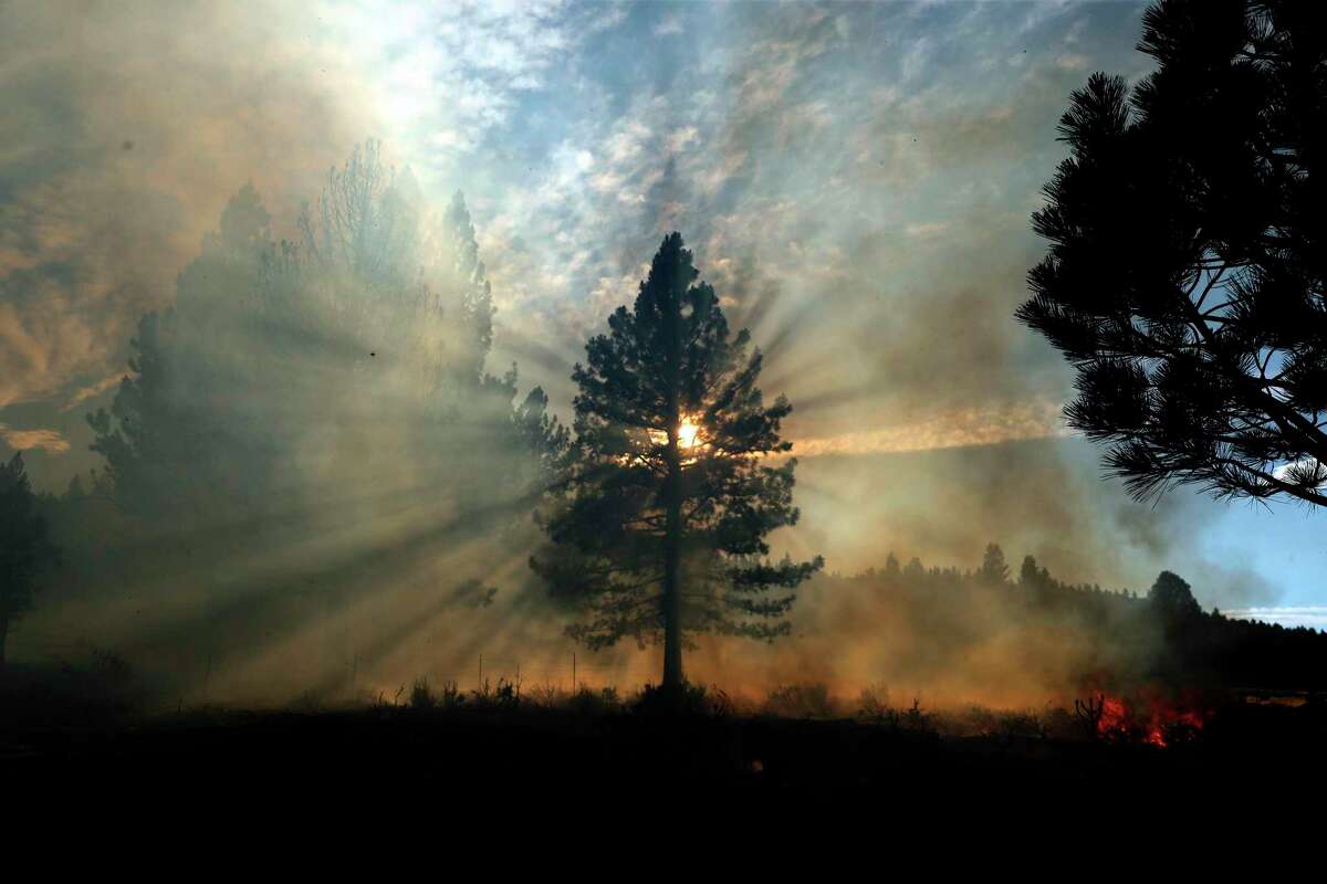 The setting sun shines through wildfire smoke during the Beckwourth Complex Fire in Lassen County.