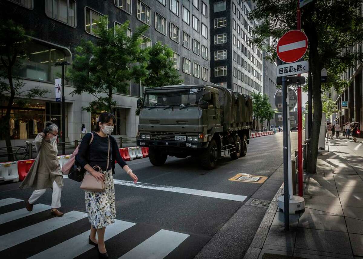 A Japanese self-defense vehicle arrives at Tokyo International Forum, one of the Tokyo Summer Olympics venues.