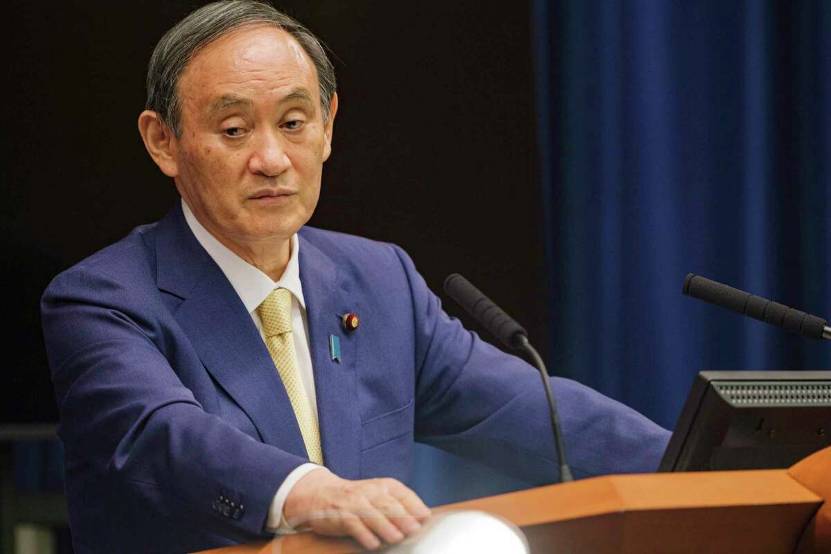 FILE - In this July 8, 2021, file photo, Japan's Prime Minister Yoshihide Suga speaks during a news conference at his official residence in Tokyo. The Tokyo Olympics are going ahead despite opposition from many quarters inside Japan. The Japanese medical community is largely against it. (Nicolas Datiche/Pool Photo via AP, File)
