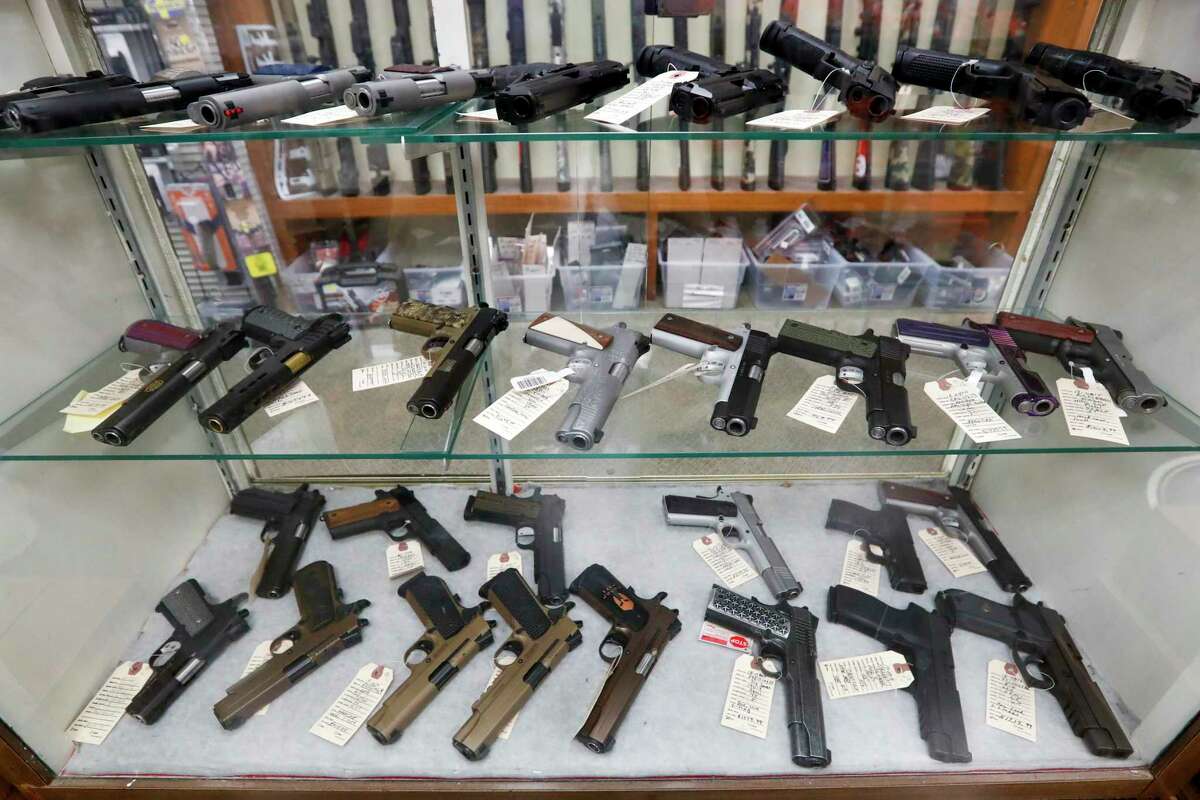 Semi-automatic handguns are displayed at shop in New Castle, Pa.