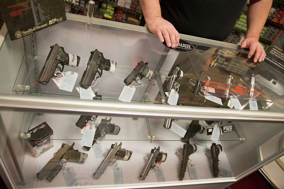 Customers shop for a handgun at Metro Shooting Supplies in Bridgeton, Miss.