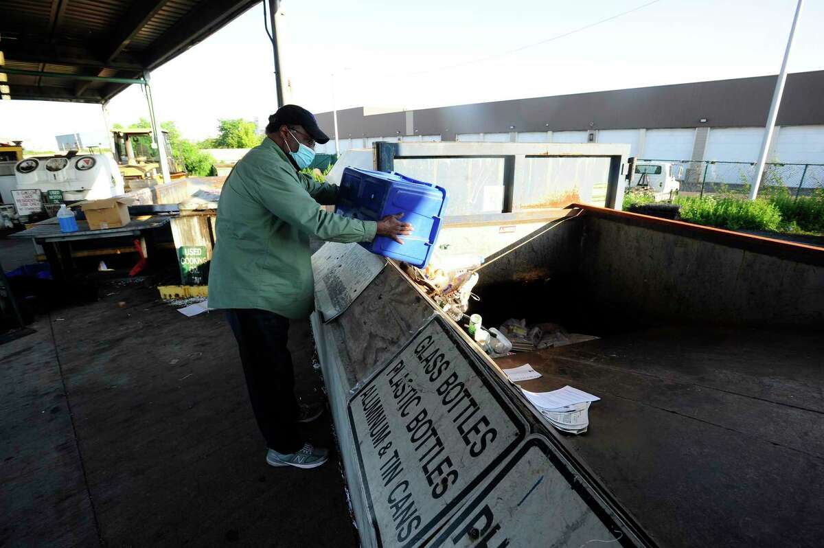 Residents dispose of recyclable household materials at the Katrina Mygatt Recycling Center on July 25, 2020 in Stamford, Connecticut.