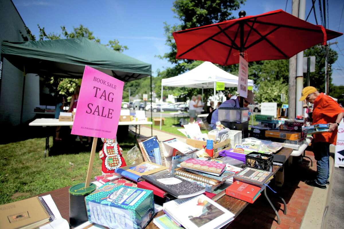 People shop the Wilton Library's book sale during Wilton's Street Fair and Sidewalk Sale at 137 Old Ridgefield Road in the town in a previous year. One of the upcoming happenings with the library is its Tag Sale featured in a Book Sale Summer Sidewalk Book Sale Street Fair and Sidewalk Sale on Saturday, July 24.