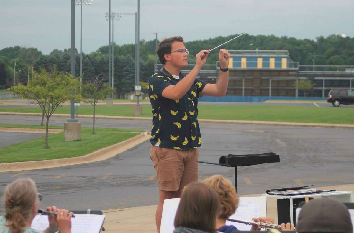 Ryan Biller conducts the Manistee Community Band during a rehearsal at Manistee Middle High School on Tuesday evening. (Kyle Kotecki/News Advocate)