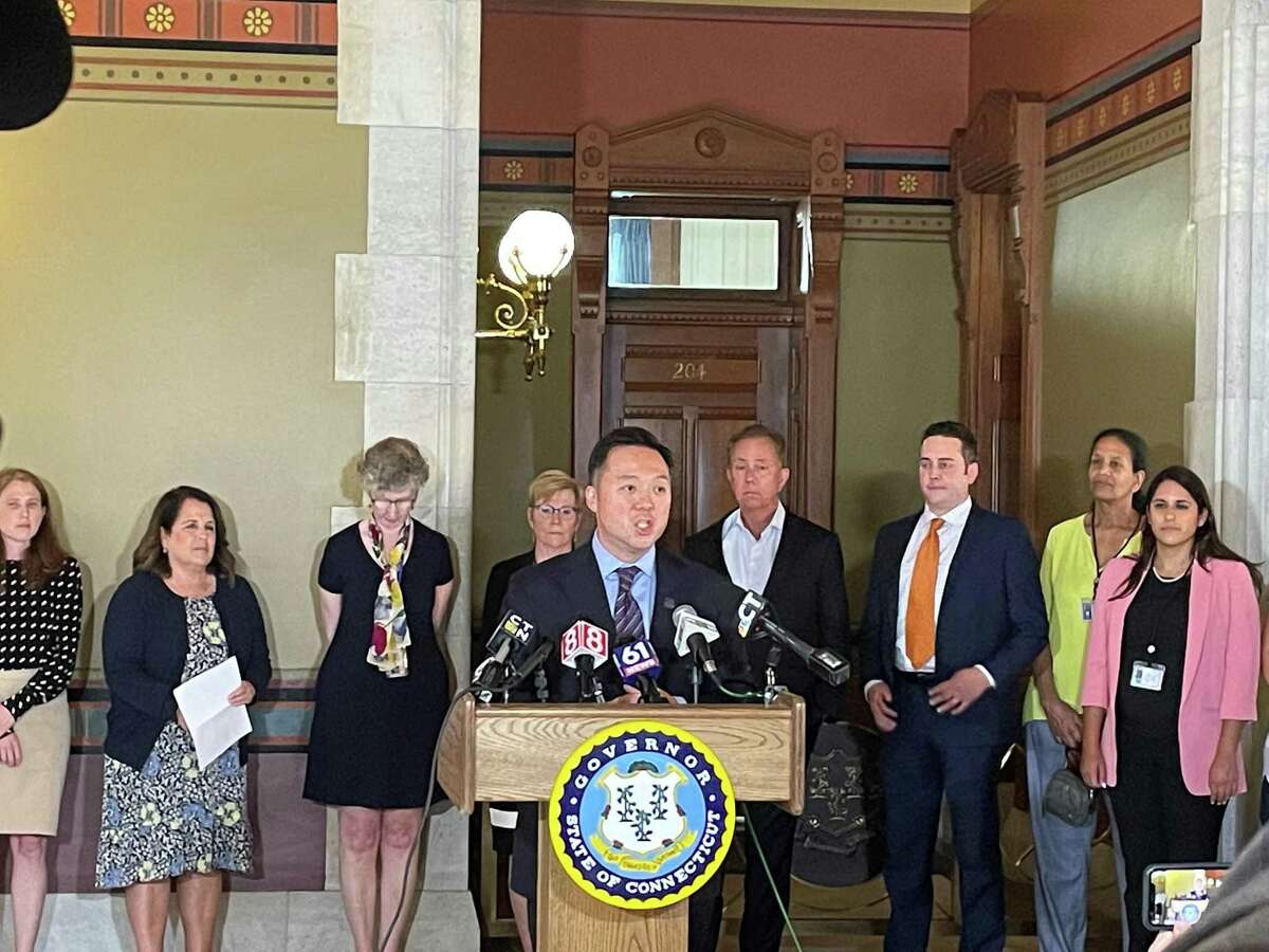 Connecticut Attorney General William Tong, center, speaks during a press conference at the state Capitol on Wednesday, July 21, 2021 to announce Connecticut’s participation in a $26 billion national settlement with AmerisourceBergen, Cardinal Health, McKesson and Johnson & Johnson related to their alleged roles in the opioid crisis.