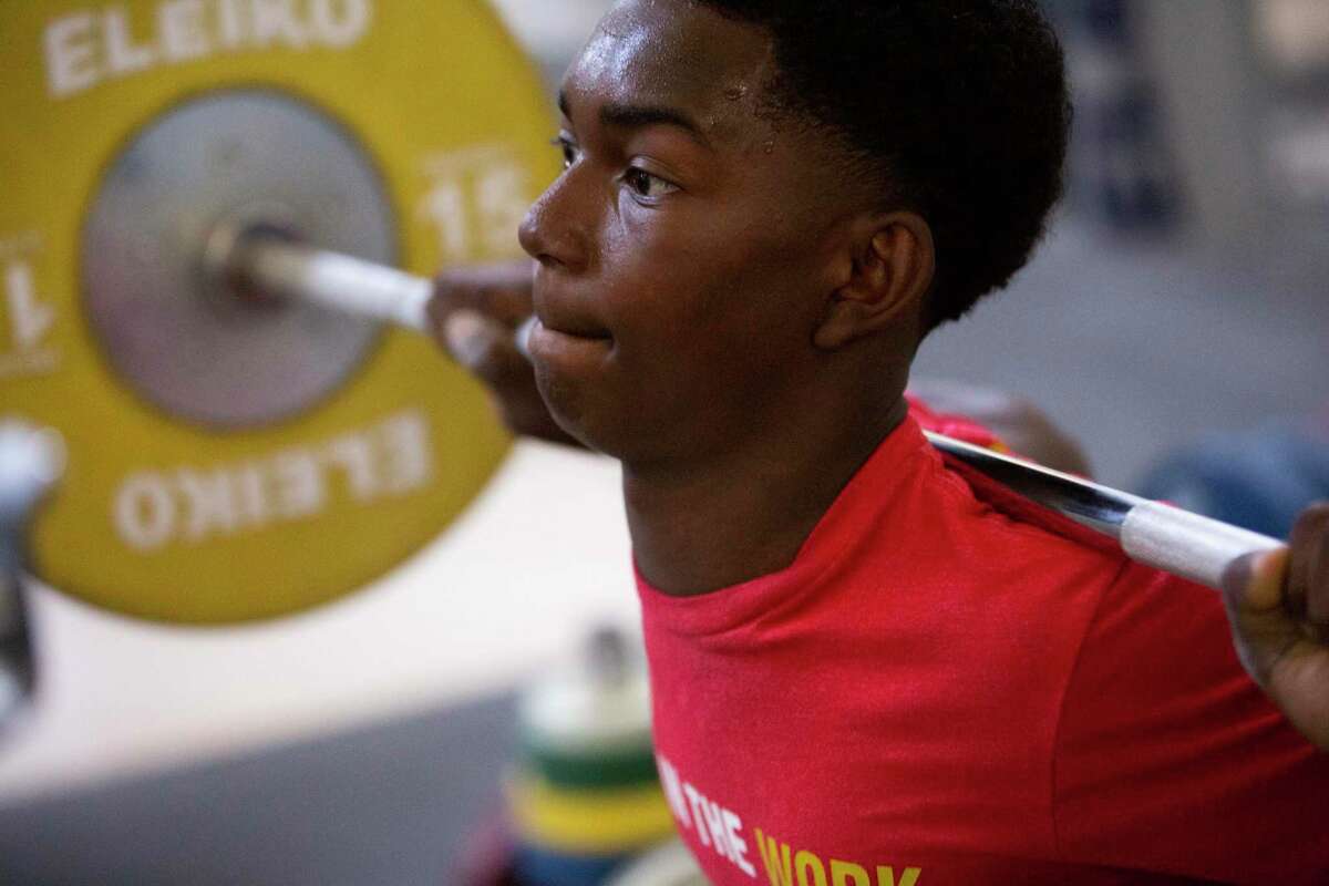 Seth Evans back squats at Speed Power Strength Gym, Wednesday, July 14, 2021, in Oakland, Calif. Evans is the U.S. champion in Olympic weightlifting in the 13-and-under age group.
