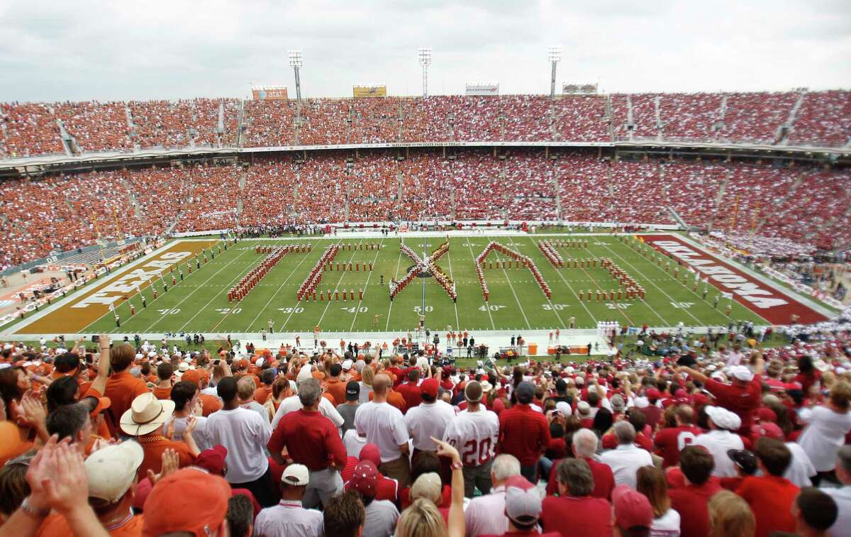 In this Oct. 8, 2011, file photo, Texas fans, left, and Oklahoma fans, right, fill the Cotton Bowl for the NCAA college football game between Oklahoma and Texas in Dallas.