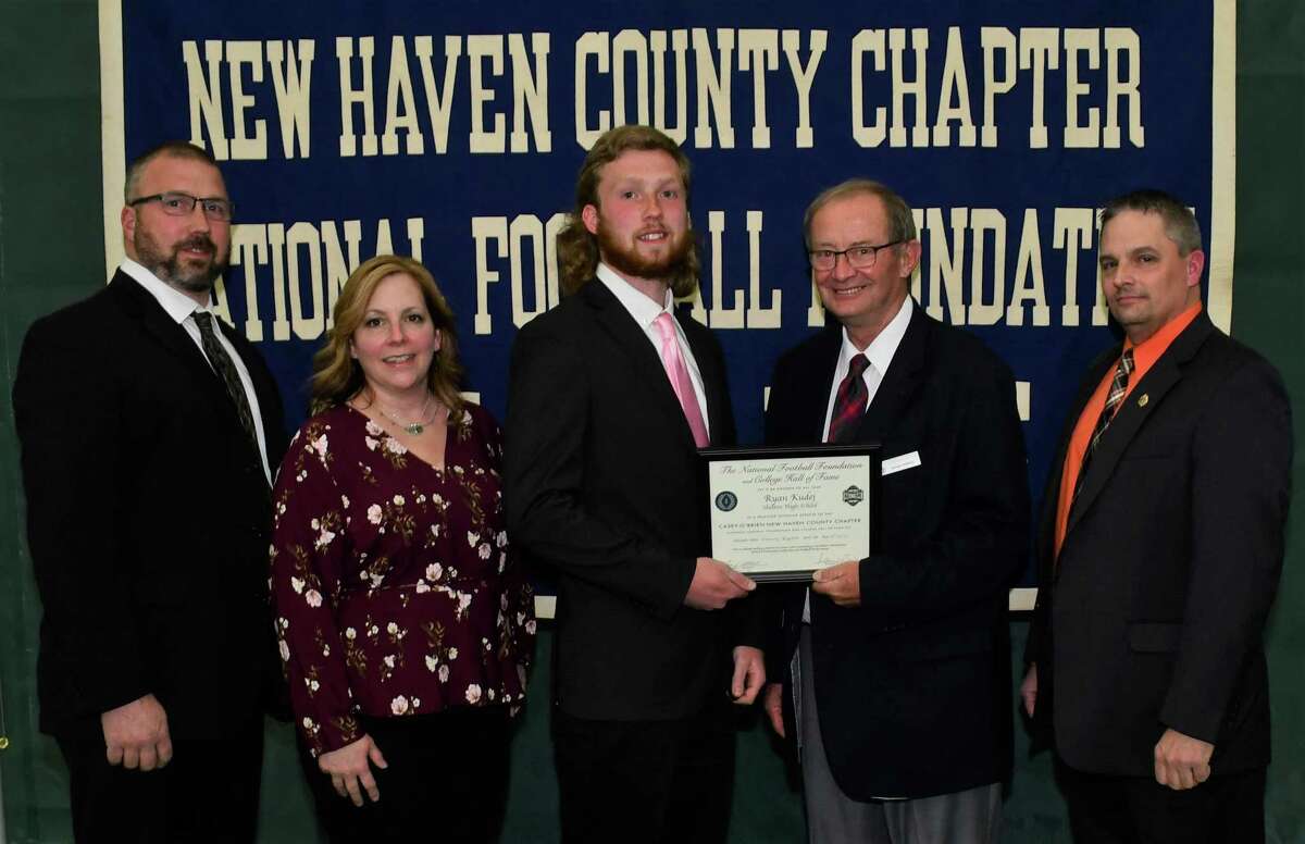 Shelton football player Ryan Kudej with parents David and Vivian, scholar athlete chairman Kevin O'Brien and Shelton coach Mike DeFelice was honored by the Casey-O'Brien New Haven County Chapter of the National Football Foundation and College Hall of Fame.