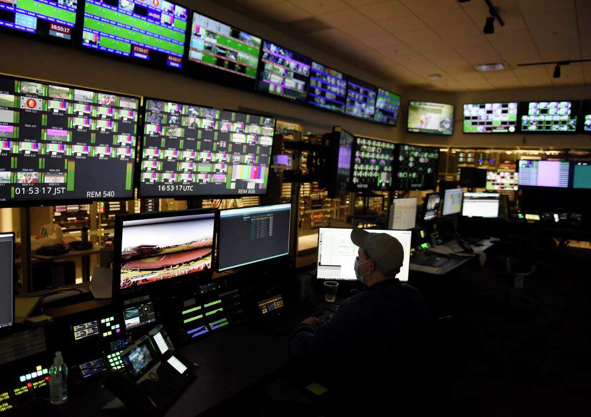 Transmission operator Kevin Kieran works in the broadcast operations center at NBC Sports headquarters in Stamford, Conn. Tuesday, July 13, 2021. NBC Sports is preparing to cover the Tokyo 2020 Olympic Games, which were postponed a year, in a different way than usual due to the lingering pandemic.