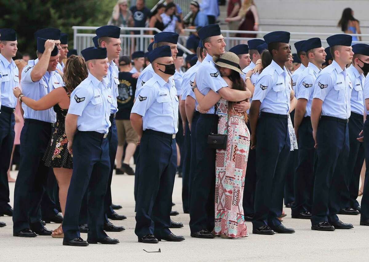 An airman gets a hug from a loved one after the Air Force holds a public graduation ceremony for basic training recruits for the first time in 16 months at JBSA Lackland in the summer of 2021.
