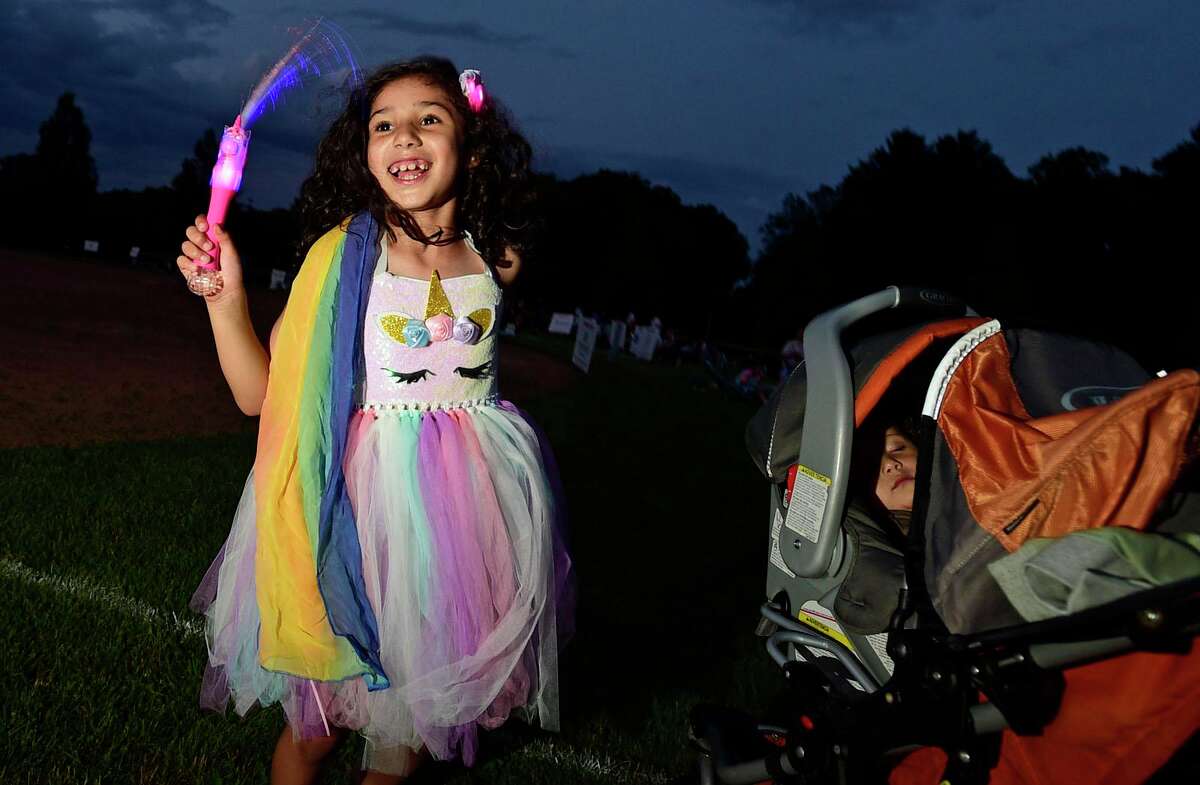 Victoria Toledo dances to the sounds of the Jerry Weiss Project during the Darien 2021 Fireworks Display at Darien High School Thursday, July 23, 2021, in Darien, Conn. Last year's display was cancelled due to the pandemic.