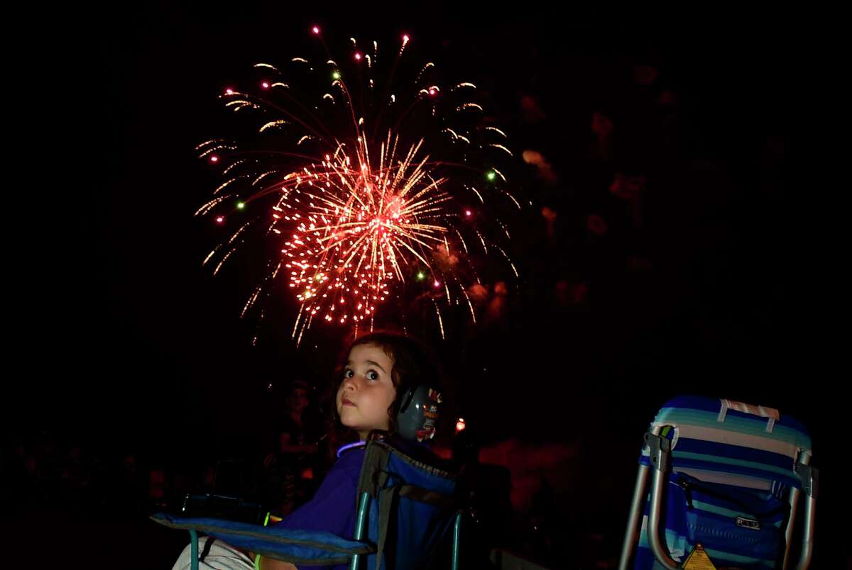 Residents enjoy the Darien 2021 Fireworks Display at Darien High School Thursday, July 23, 2021, in Darien, Conn. Last year's display was cancelled due to the pandemic.