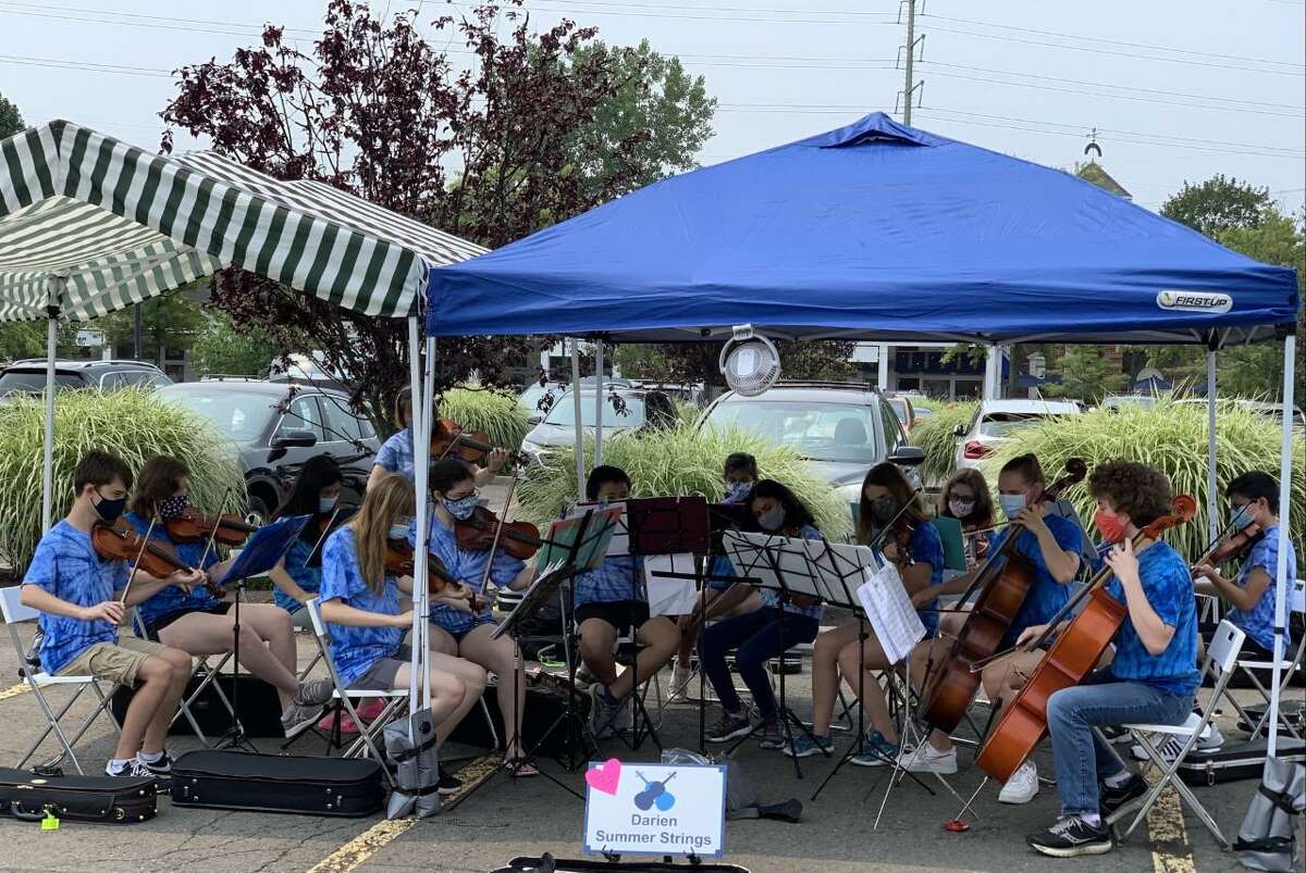 The Darien Summer Strings group of musicians recently treated shoppers to a concert of familiar favorite songs on Wednesday, July 24, at the Darien Farmers Market in the Goodwives Shopping Center in the town.