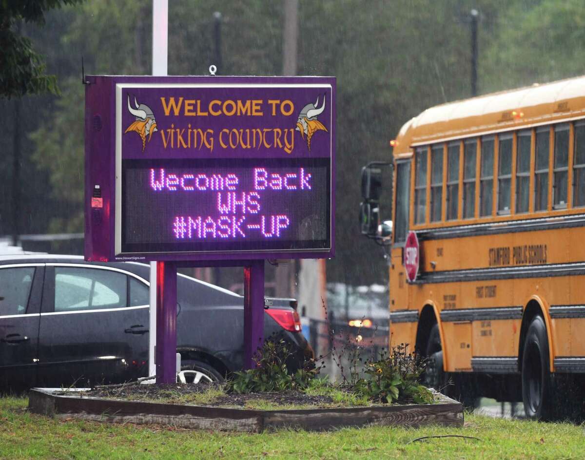 A sign reminds students to wear their masks as they return for the first day of the 2020-2021 school year at Westhill High School in Stamford last year.