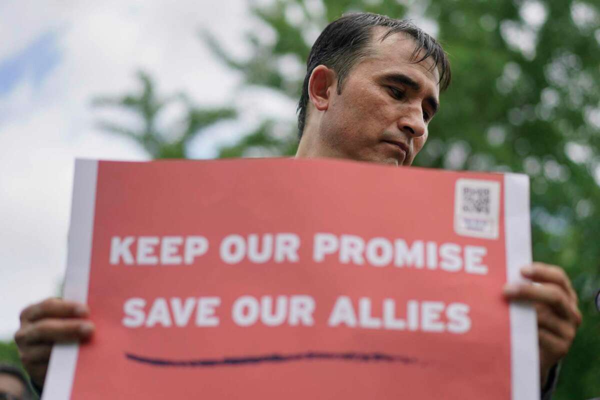 Abdul Wahid Forozan, a former translator for the American military in Afghanistan, holds a sign that reads “Keep Our Promise Save Our Allies” near the White House in Lafayette Square Park in Washington on July 1 during a rally hosted by the International Refugee Assistance Project, Human Rights First, and With Honor Action, to call for the evacuation of Afghan allies.