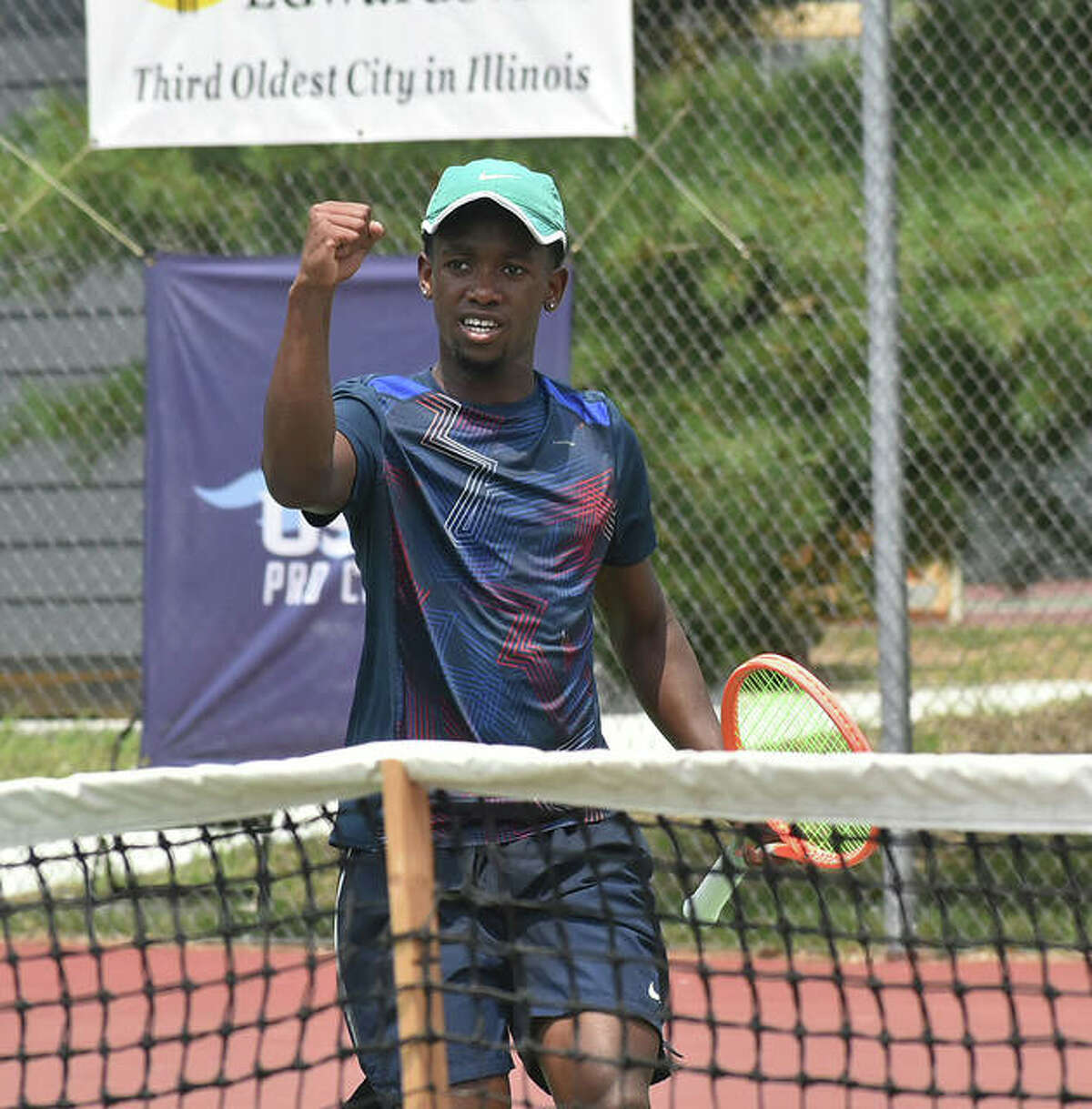 Siphos Montsi pumps his fist in celebration after breaking serve and taking the first game of the third set against Paul Jubb in the second round on Thursday in the Edwardsville Futures tennis tournament.