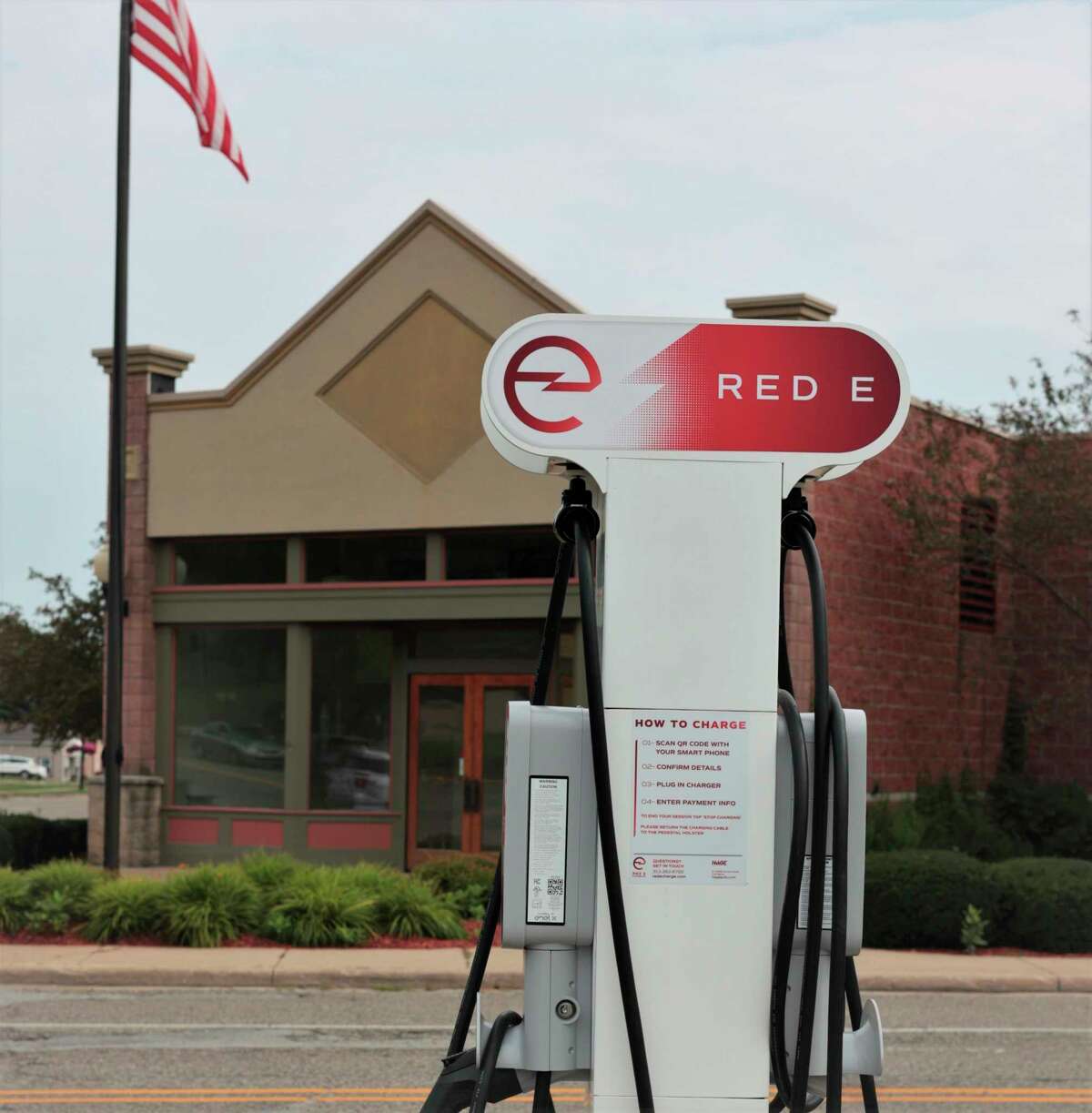 A Red E Charging Station is situated at the parking lot on Washington Street in downtown Manistee across the street from North Channel Brewing Company. (Jeff Zide/News Advocate)